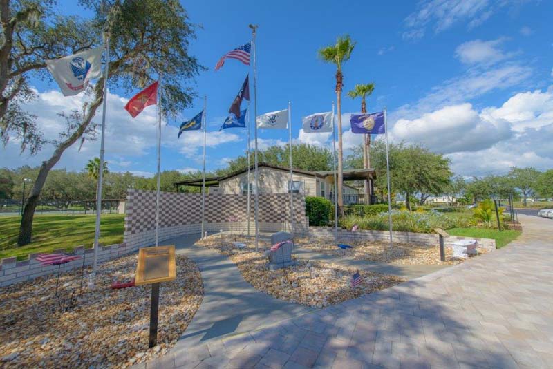 Club house cart path with row of waving flags 